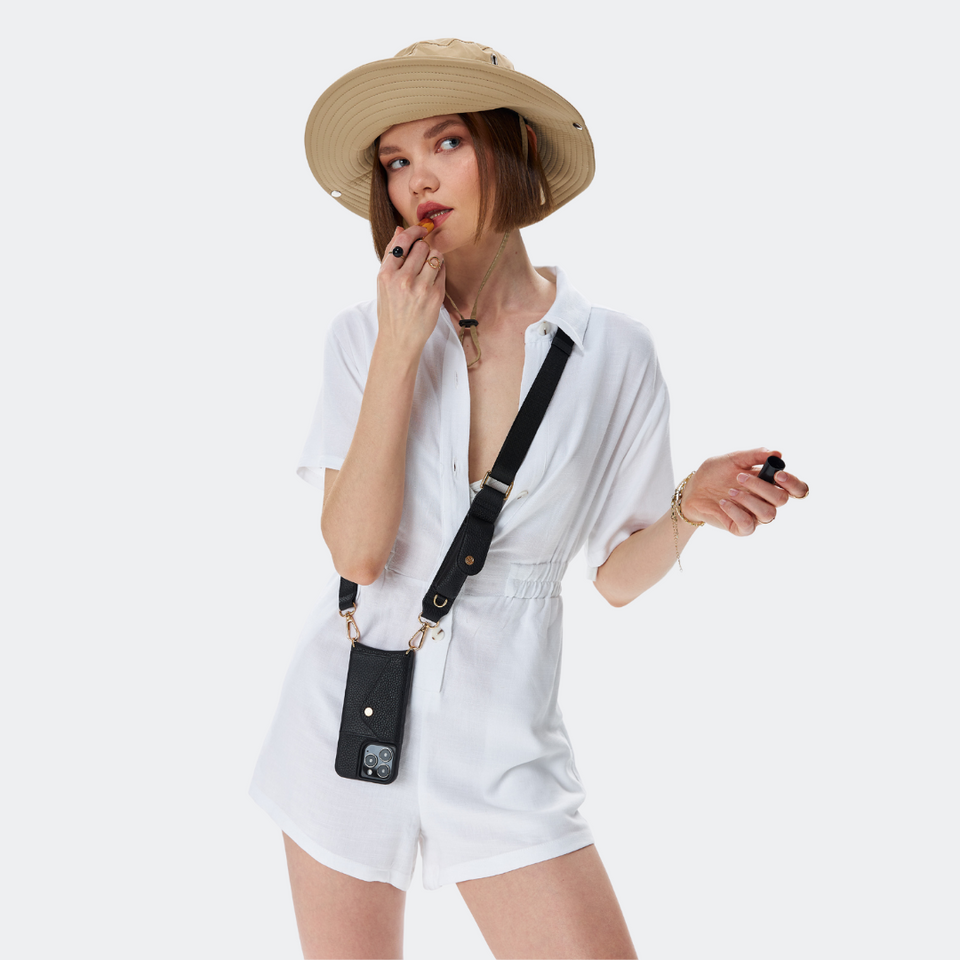 Black Bandolier-style Side angle view of a black leather crossbody phone case, highlighting the adjustable leather strap and slim profile