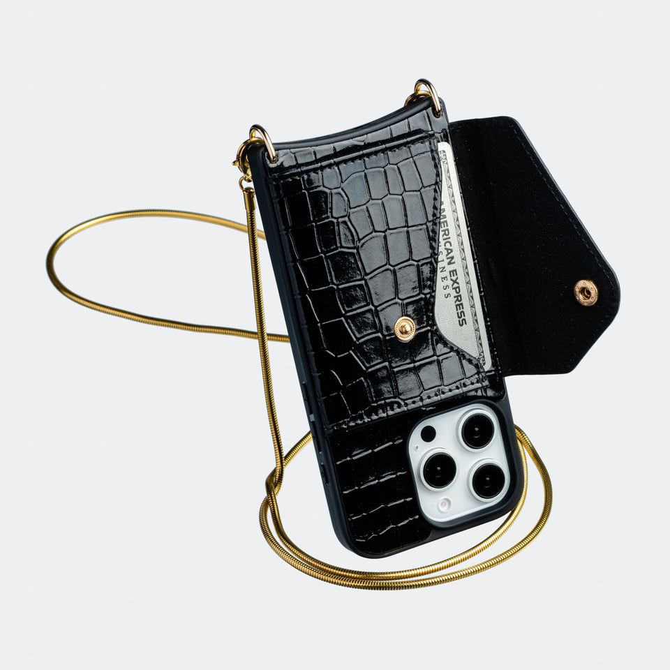 Side angle of the black vegan leather crossbody phone case, showcasing its adjustable strap and slim, minimalist profile.
