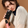 Model wearing the black Bandolier-style leather crossbody phone case, demonstrating its practicality with the adjustable strap comfortably slung over the shoulder.